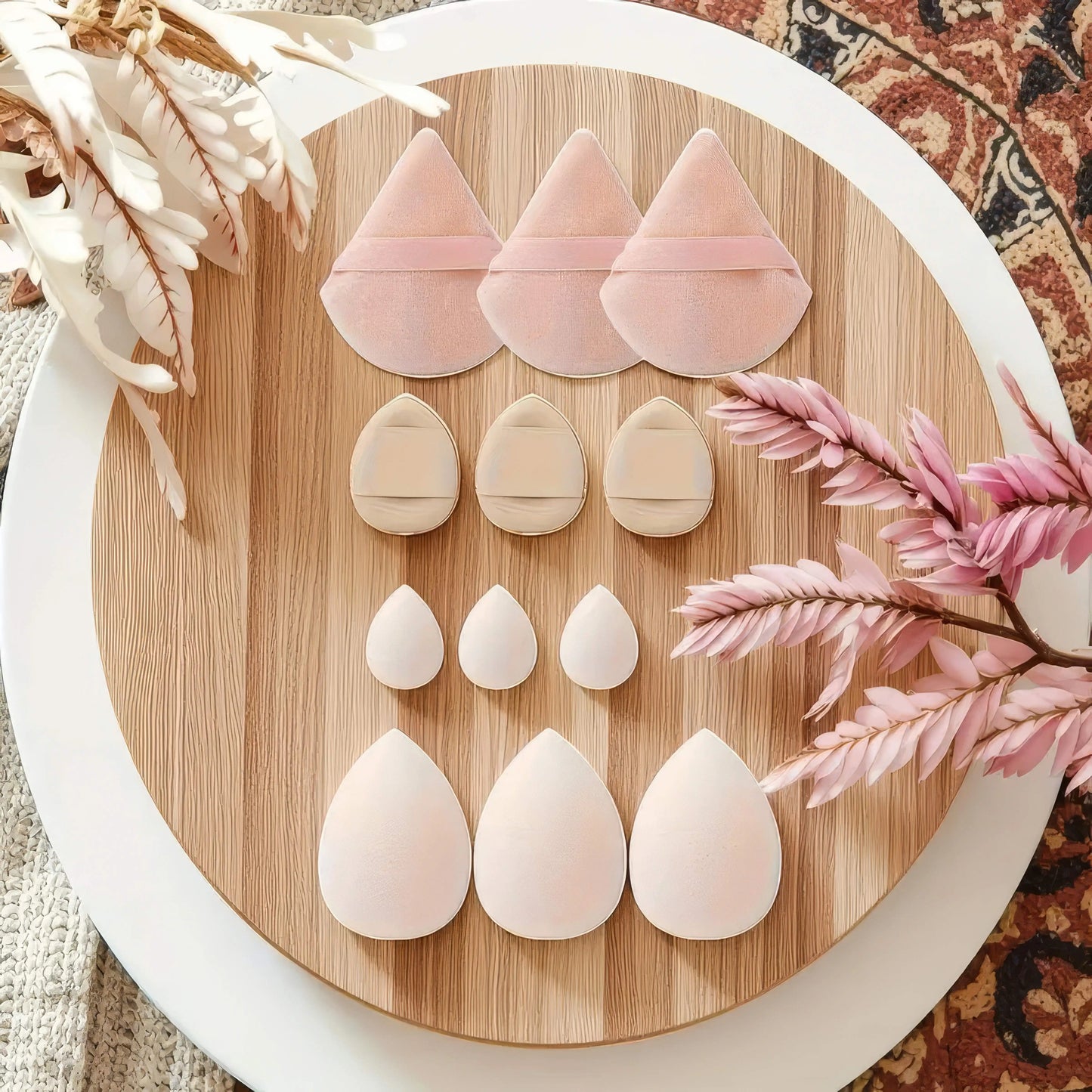 A professional set of twelve soft beauty blenders designed for smooth and flawless liquid foundation application.