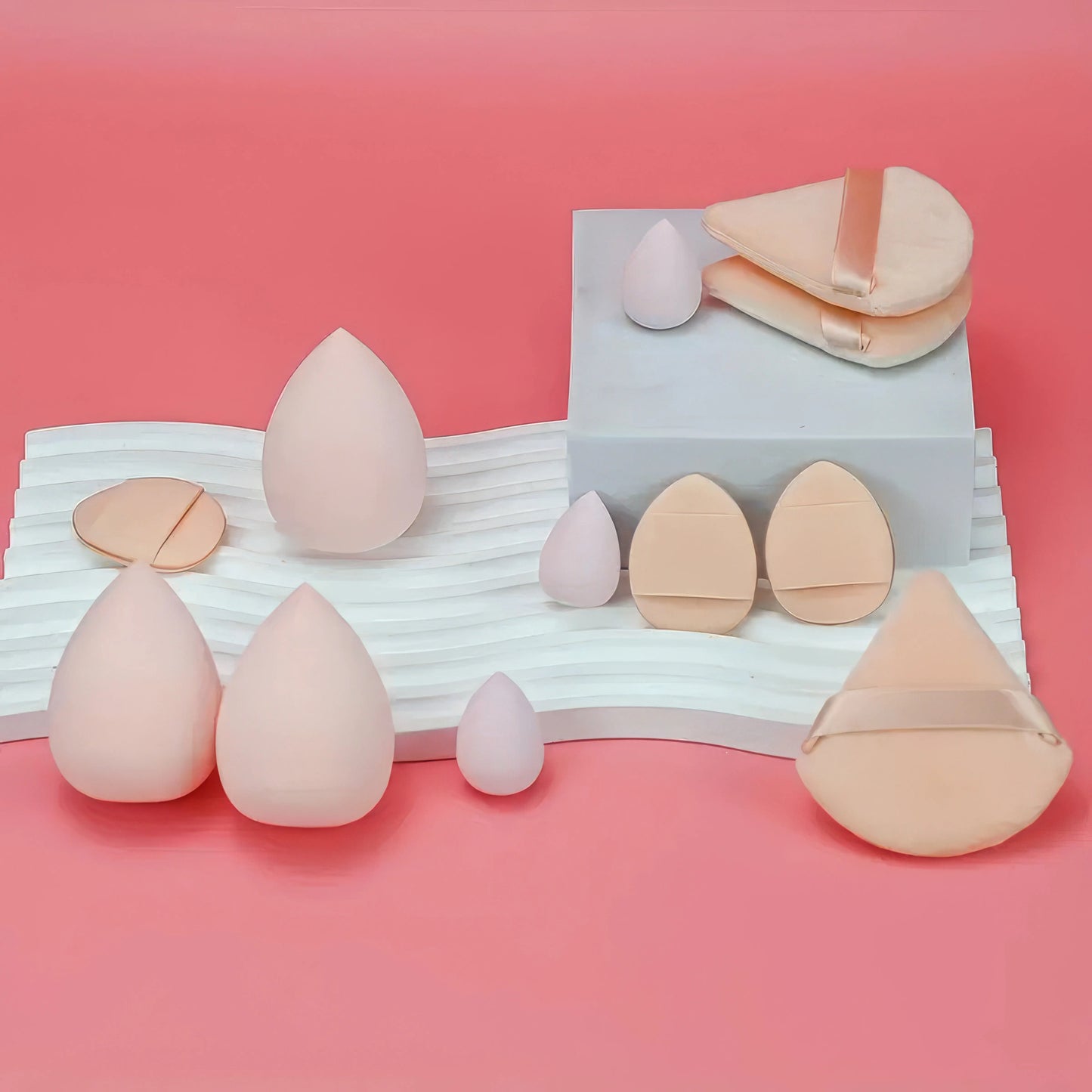 A professional set of twelve soft beauty blenders designed for smooth and flawless liquid foundation application.